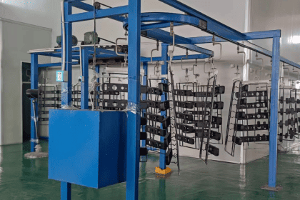 Door handle painting process in a manufacturing facility.